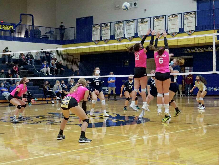 Morley Stanwood seniors Brooke Brauher and Landrie LaPreze go virtual to block a ball during a match against Lakeview earlier this season. (Pioneer file photo)