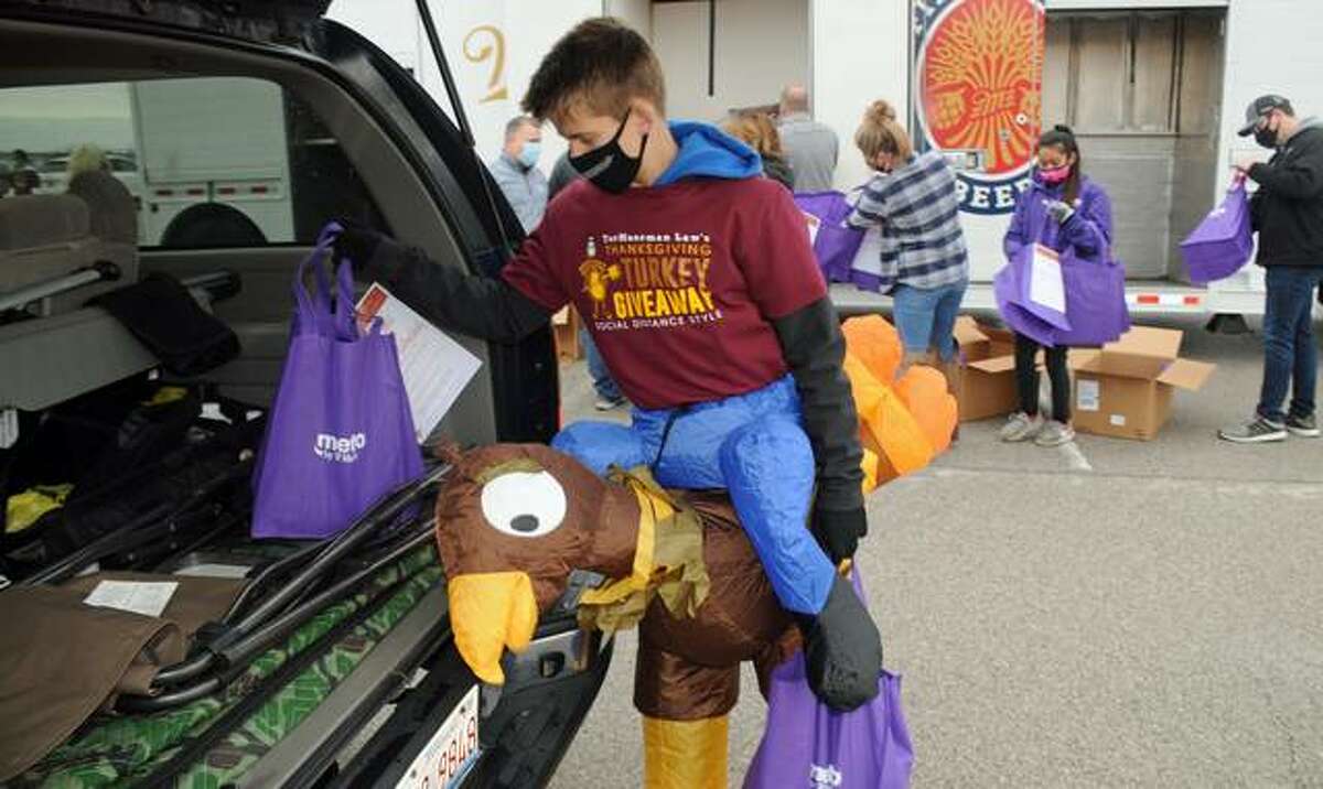 Andrew Roth, the son of a TorHoerman Law employee, donned festive attire as he helped to load free turkeys into waiting vehicles on Saturday. The firm gave away 600 turkeys on Saturday, the seventh year it has helped provide area families with Thanksgiving dinners.