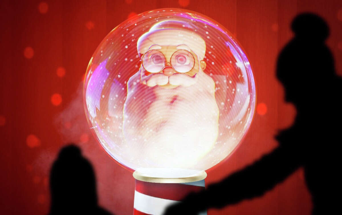 The innovative holiday installation features a three-dimensional Santa Claus inside a giant snow globe.