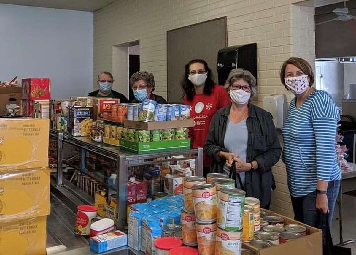 The Woman’s Club of Greater New Milford and the United Way recently teamed up to collect food to assemble Thanksgiving food baskets for families this holiday season. Operation Thanksgiving, a food drive held earlier this month, collected the majority of items needed to supply a complete Thanksgiving meal for nearly 300 families in the community this season. Above, volunteers, from left to right, Allie Franco, Janine Battaglia, Adrienne Kern, Tricia Gregory and Priscilla Williams wrap up their sorting duties last weekend at the John Pettibone Community Center.