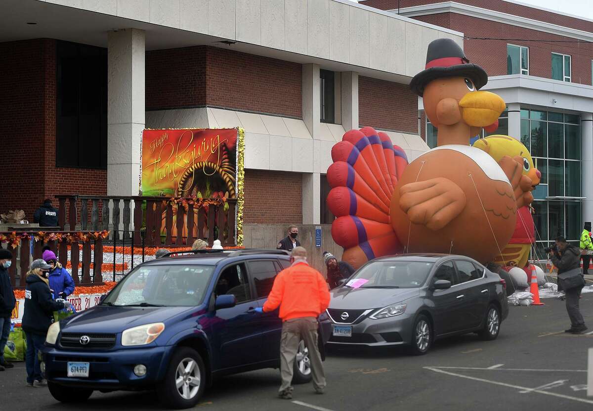 Above, cars line up to receive frozen Thanksgiving turkeys at the Stamford Downtown Parade Spectacular Giving Float on Bedford Street on Sunday. Stamford Downtown partnered with Person-to-Person, ShopRite, New Wave Seafood and the Connecticut Office of Tourism to provide Thanksgiving meals to 500 Stamford families.