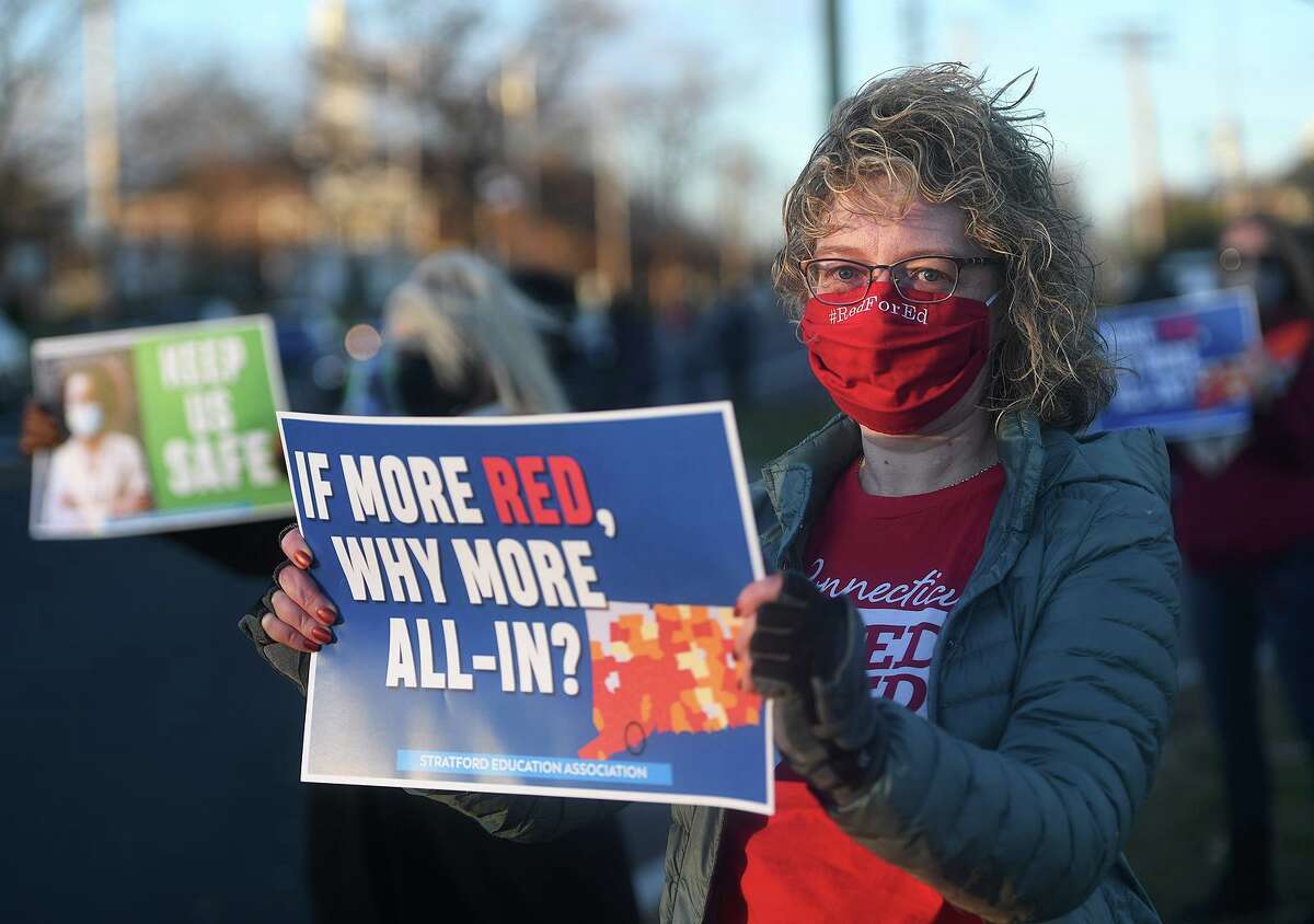 Kristen Record, co-vice president of the Stratford Education Association, the Stratford teachers' union, protests COVID-19 inaction with fellow teachers on Main Street in Stratford, Conn. on Monday, November 23, 2020.
