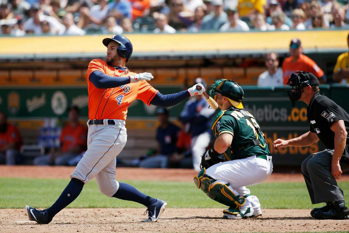 Houston Astros center fielder George Springer (4) swings and misses against Oakland Athletics starting pitcher Trevor Cahill (53) during an MLB game between the Oakland Athletics and Houston Astros at the OaklandÐAlameda County Coliseum on Saturday, Aug. 18, 2018, in Oakland, Calif.
