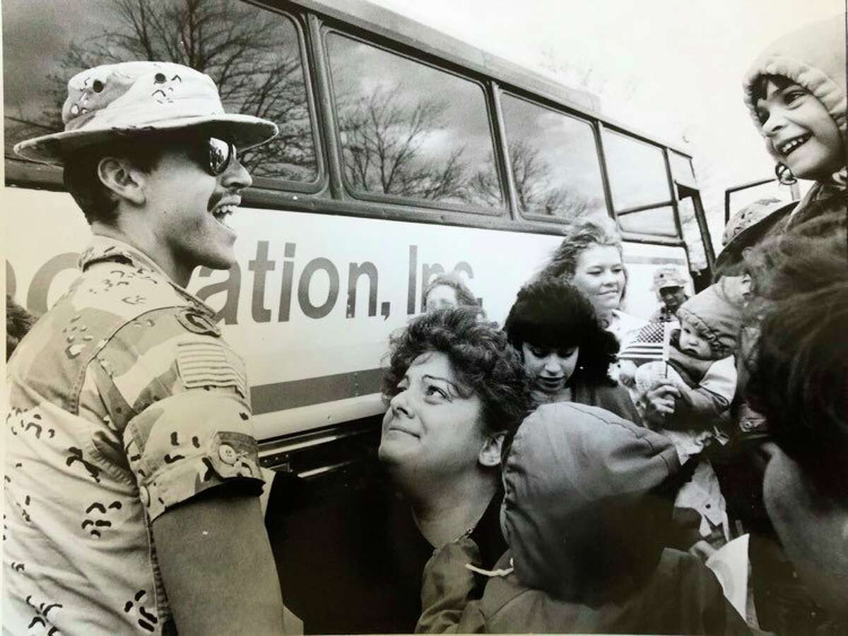 In this photo dated May 1, 1991, Sgt. Laurance Robert Flemming Jr. is greeted with a mix of adoration and happiness by his family - wife, Lauri; Amanda, 4, far right, and Robert, 1, bottom with back to the camera. (Daily News file photo)