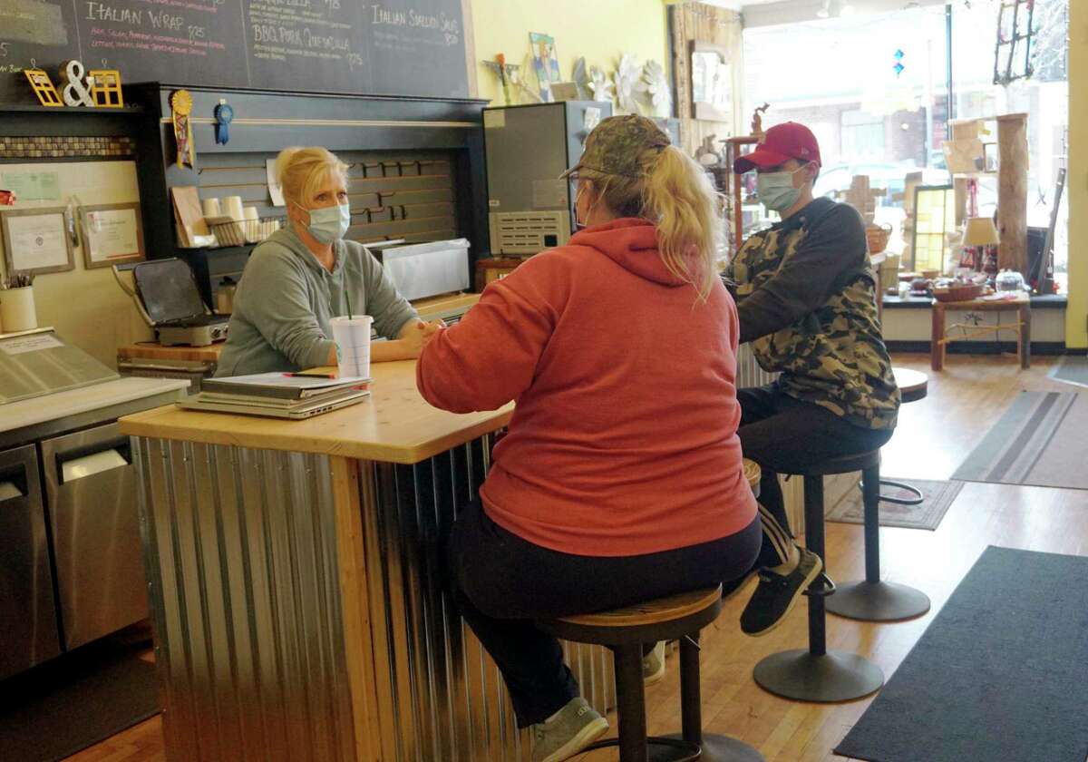 Yellow Window owner Kelly Dennis speaks with some customers at her lunch counter during business hours last week. (Pioneer photo/Joe Judd)