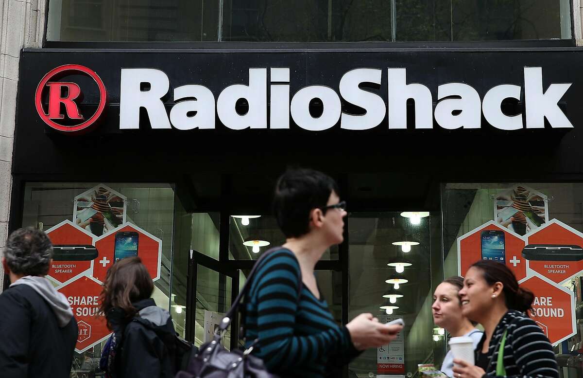 People walk by a Radio Shack store on March 4, 2014 in San Francisco, California. RadioShack announced plans to close over 1,000 of its underperforming stores, approximately 20 percent of its retail locations, as part of a restructuring to be more competitive in retail electronics. (Photo by Justin Sullivan/Getty Images)