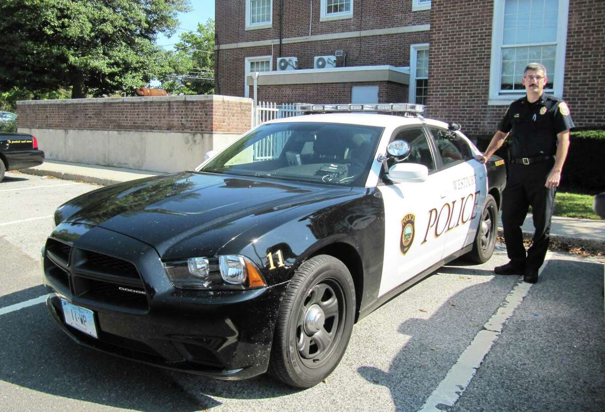 Pictured is Dale Call, deputy chief of the Westport Police Department, posing next to one of the department's newest cruisers, a 2011 Dodge Charger with a new "Westport Police" graphics scheme.