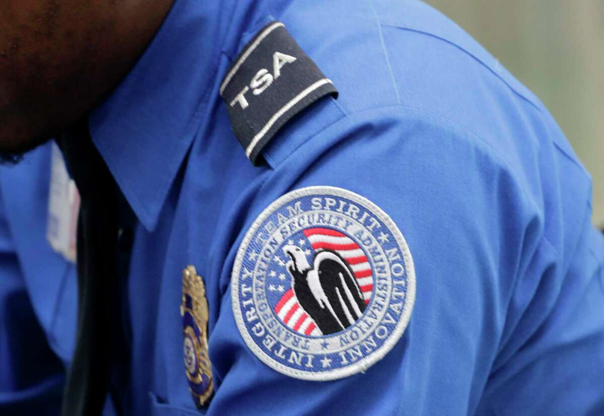 A TSA shoulder patch is shown on the uniform of a Transportation Security Administration officer at John F. Kennedy International Airport, Thursday, Oct. 30, 2014 in New York. (AP Photo/Mark Lennihan)