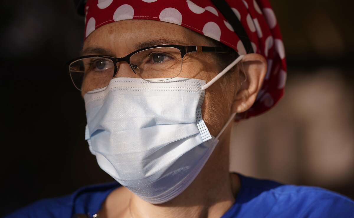 Nurse Teri Wheat poses for a photo in Fort Worth, Texas, Thursday, Nov. 19, 2020. As Wheat recently made her rounds at a Texas maternity ward, she began to realize she was having a hard time understanding the new mothers who were wearing masks due to the coronavirus pandemic. Hearing specialists across the U.S. say they have seen an uptick in visits from people like Wheat, who only realized how much they relied on lip reading and facial expressions when people started wearing masks that cover the nose and mouth. (AP Photo/LM Otero)