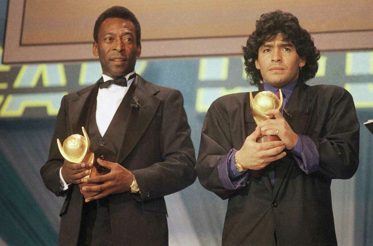 FILE - In this March 1987 file photo, Pele, left, and Maradona hold "Sports Oscar" trophies in Milan, Rome. The Argentine soccer great who was among the best players ever and who led his country to the 1986 World Cup title before later struggling with cocaine use and obesity, died from a heart attack on Wednesday, Nov. 25, 2020, at his home in Buenos Aires. He was 60.