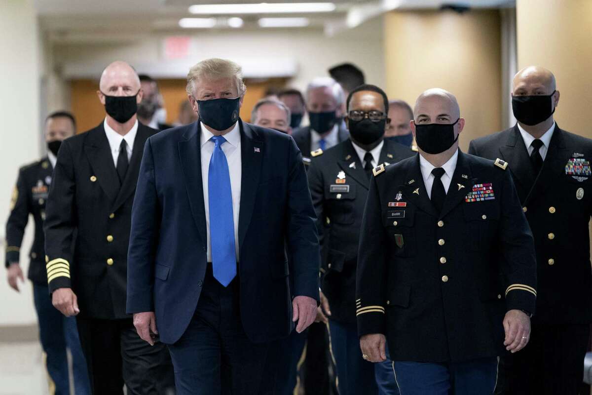 President Donald Trump wears a protective mask while visiting Walter Reed medical center on July 11.