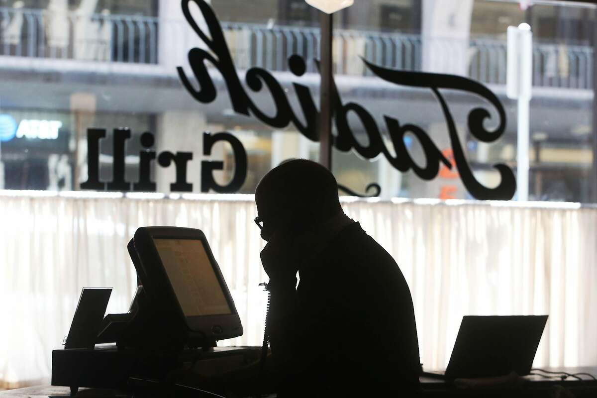 David Hanna, General Manager of Tadich Grill, takes an order over the phone while working at Tadich Grill in July. The restaurant is closed for the foreseeable future.