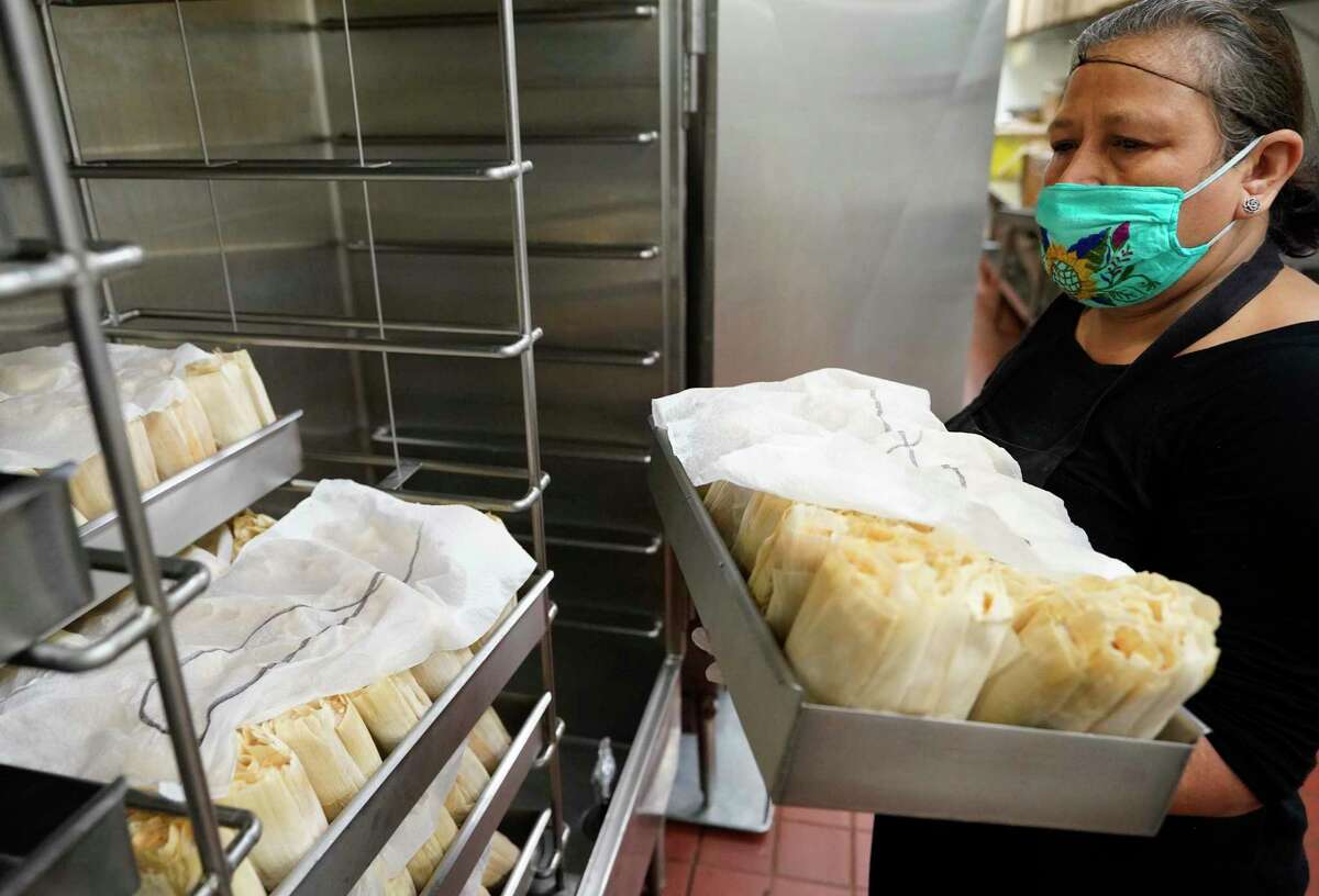 Evelia Torres places tamales into a cooker at Balderas Tamale Factory, 12139 Jones Rd., Thursday, Nov. 19, 2020 in Houston. The tamales with cook for 8 hours.