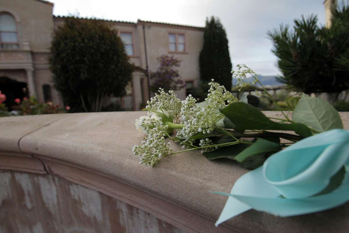 A flower lies atop the fence at Robin Williams’ former home in the Sea Cliff neighborhood in San Francisco on August 11, 2014. Fans and friends left flowers and notes to honor the late comedy and acting legend.