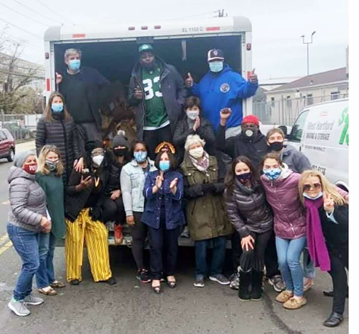 Toni Boucher, center, along with many volunteers, helped gather, put together, and deliver 500 paper bags of donated Thanksgiving