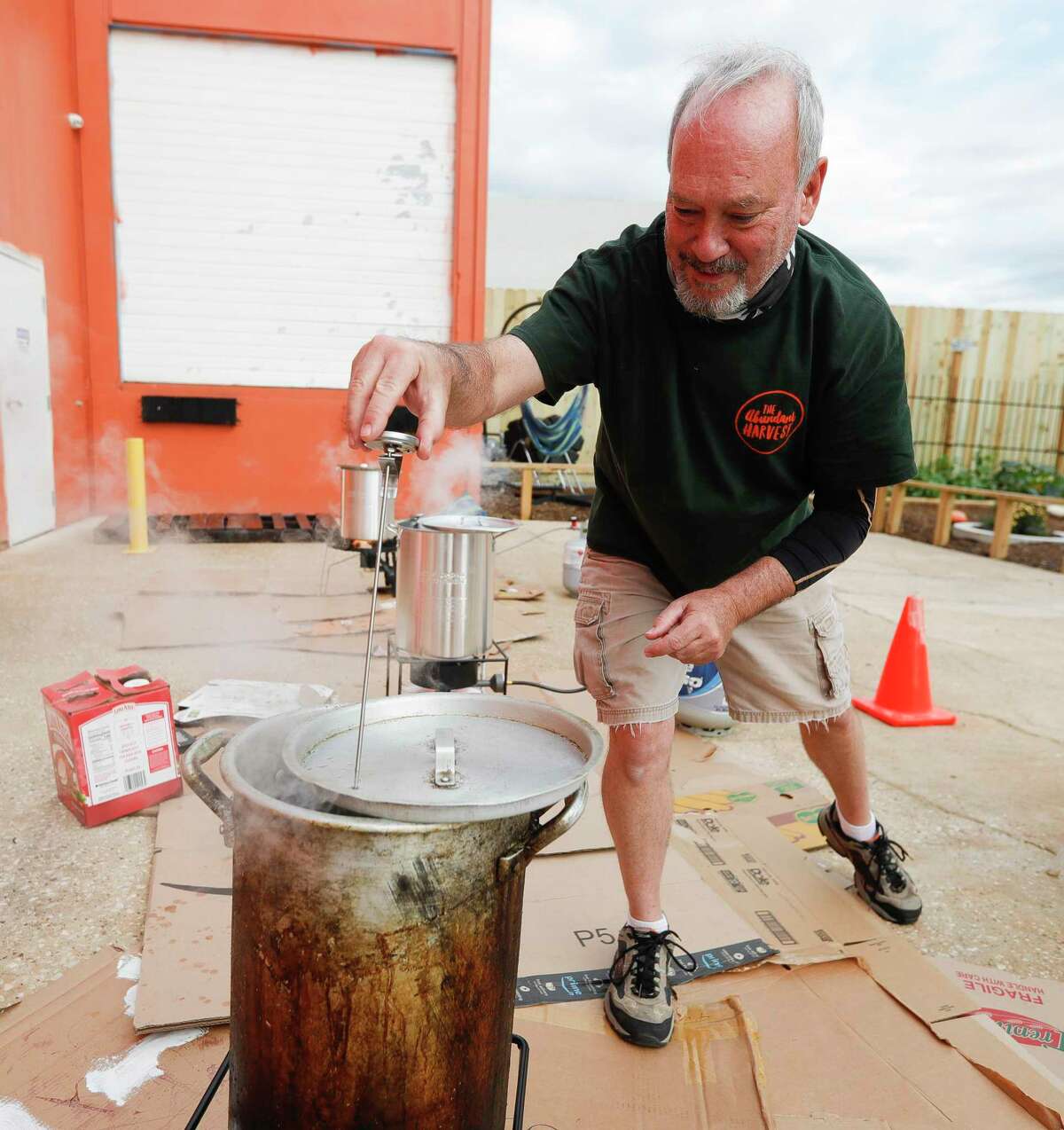 Paul McKelvey checks the temperatures as he helps fry 30 turkeys at The Abundant Harvest, Wednesday, Nov. 25, 2020, in Spring. Saint Isidore Episcopal Church hosted a turkey fry fundraiser and recently opened its cafe to company the organziation’s kitchen and food pantry outreach.