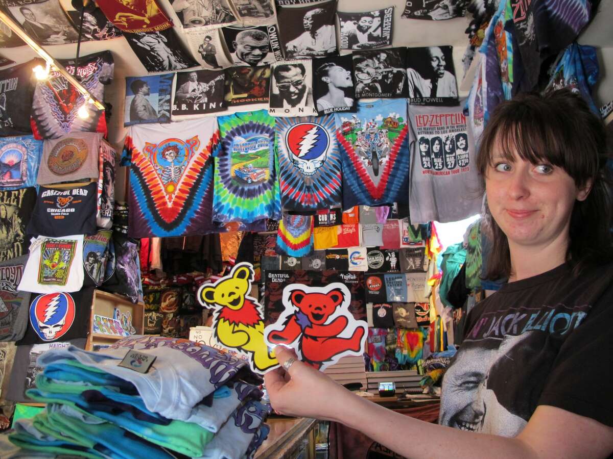 Greta Marti, co-owner of Haight Ashbury T-Shirts, holds up stickers of the Grateful Dead's marching bears at her family's shop on July 1, 2015. The 43-year-old shop will close at the end of December due to the pandemic and lack of foot traffic in the area.