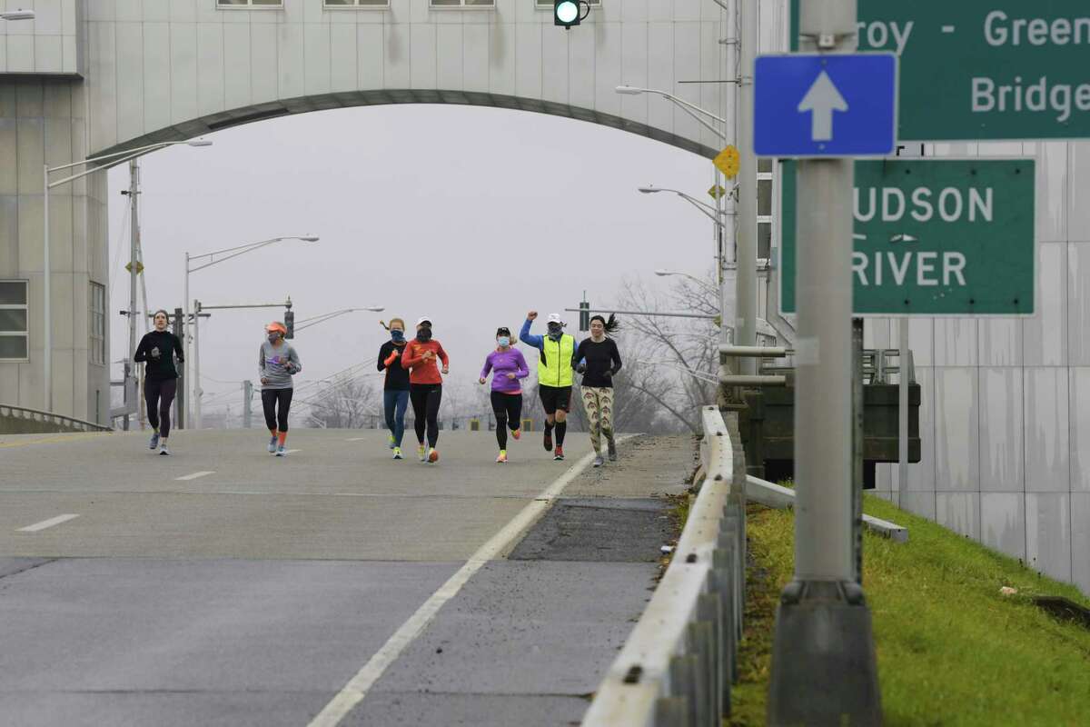 Runners cross the Green Island Bridge in November. (Paul Buckowski/Times Union)