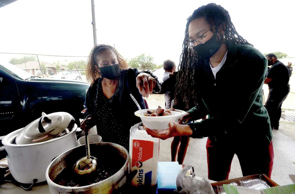 Gloria Garrison (left) and family, including Britany Kinlaw, gather round to serve up homemade gumbo to the homeless at an encampment on 9th Avenue in Port Arthur Thursday afternoon. Photo taken Thursday, November 26, 2020 Kim Brent/The Enterprise