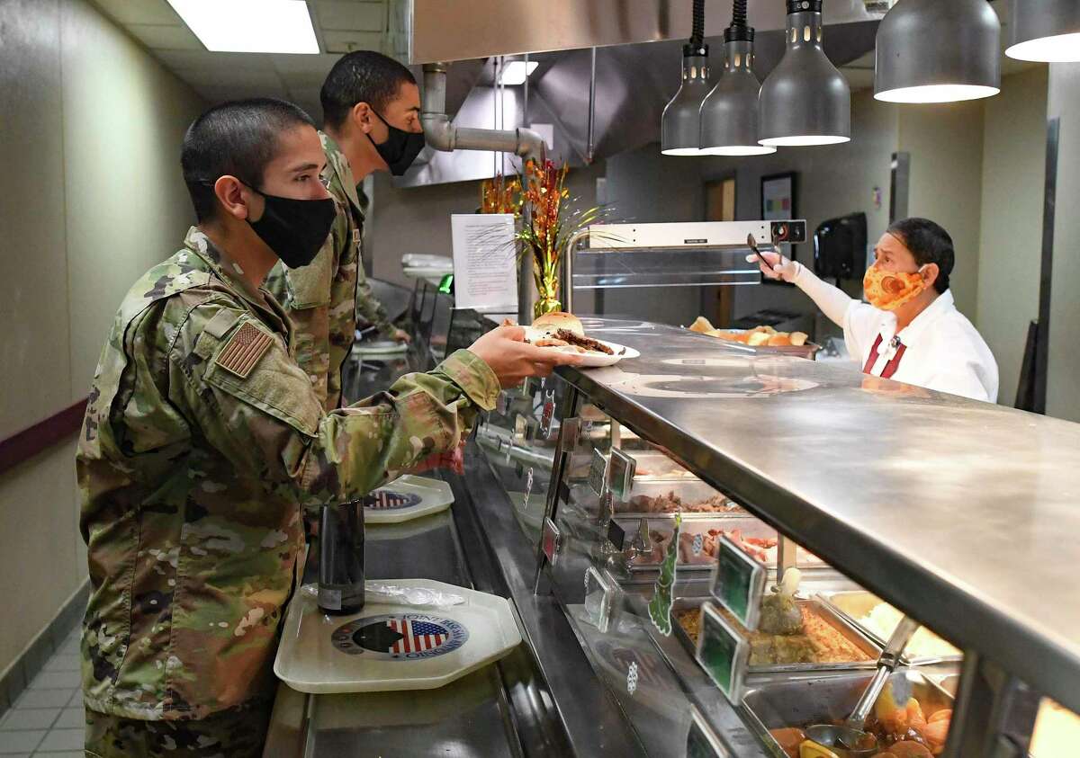Some of the 708 Basic Military Training graduates grab a Thanksgiving meal at the Barnes Training Complex at JBSA-Lackland on Thanksgiving Day, Nov. 26, 2020. Meals are usually eaten in silence, but on this day, the graduates were encouraged to socialize and celebrate.