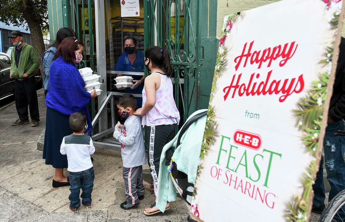 Community members in need gather outside Bethany House of Laredo Thursday, Nov. 26, 2020, to receive a grab and go holiday meal during a distribution of groceries and meals sponsored by H-E-B.