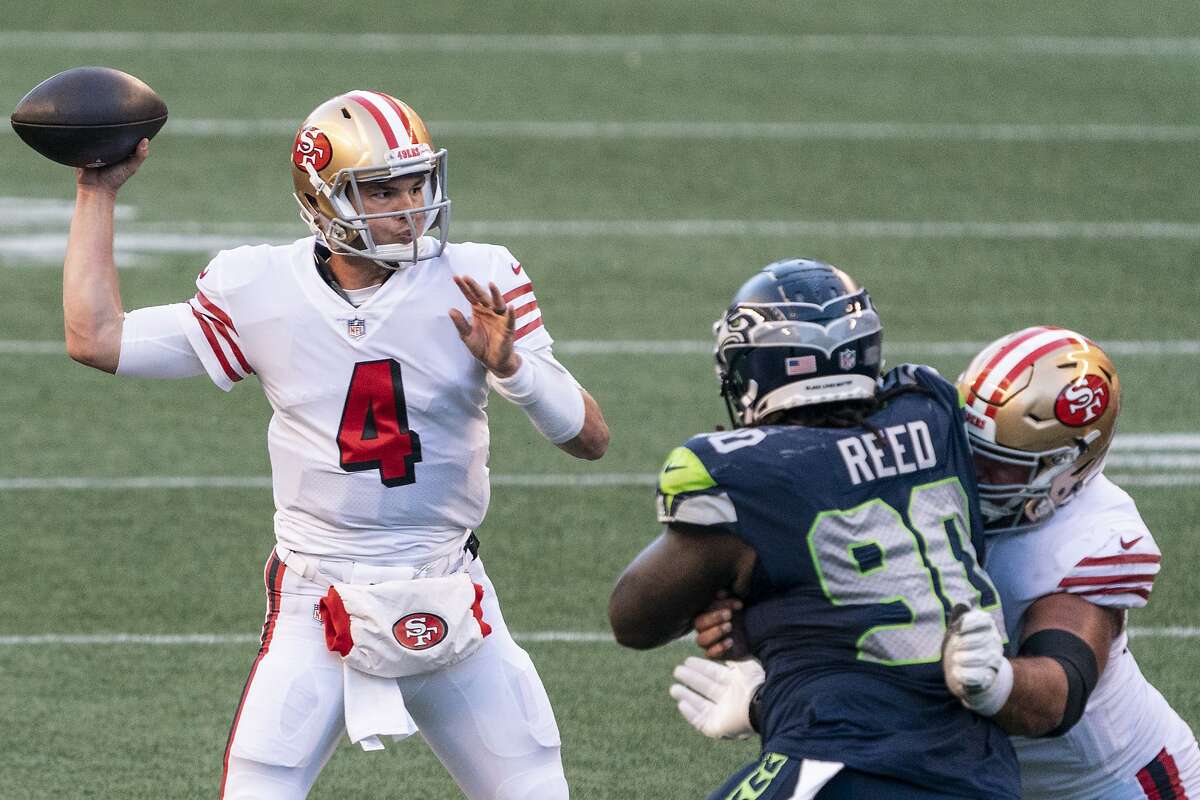 San Francisco 49ers quarterback Nick Mullens passes the ball during the second half of an NFL football game against the Seattle Seahawks, Sunday, Nov. 1, 2020, in Seattle. The Seahawks won 37-27. (AP Photo/Stephen Brashear)