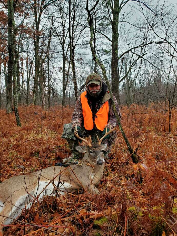 Roger Kent of Luther is pictured with his 8-point buck he shot on opening day. (Courtesy photo)