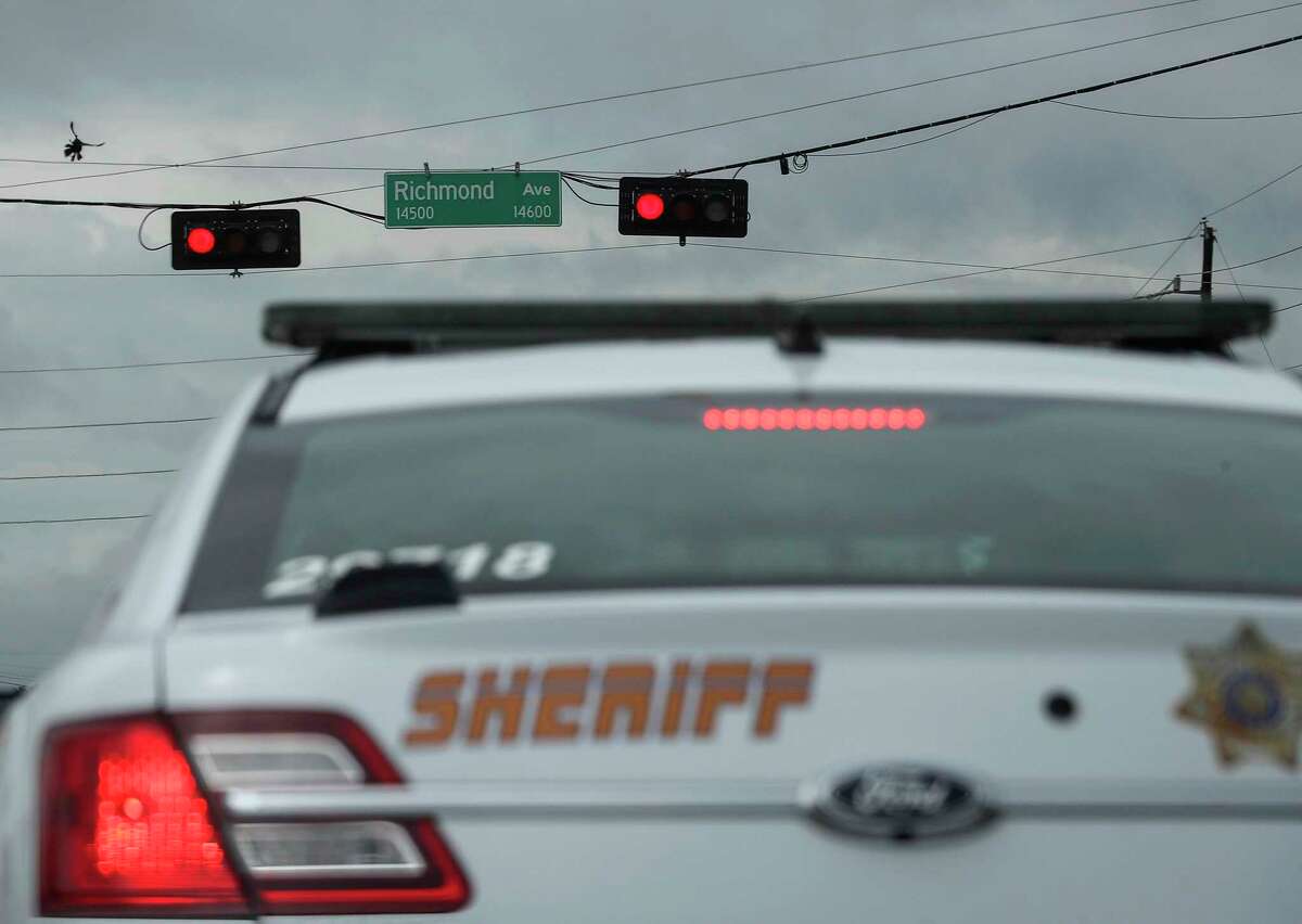 Harris County Sheriff's Deputy waits at a red light on June 24, 2020, at the intersection Richmond Avenue and State Highway 6 in Houston.