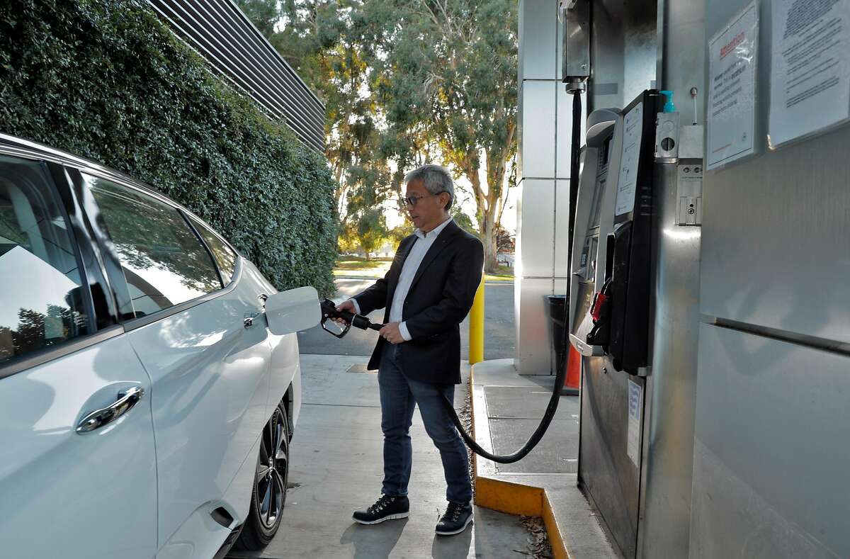 Tadashi Ogitsu refuels his hydrogen fuel cell Honda Clarity near his home in San Ramon, Calif., on Wednesday, November 25, 2020. California’s push to phase out gas-powered cars has often focused on the future of battery-electric models. But a rival technology still in its infancy, hydrogen fuel-cell electric cars, could be a key part of the solution. California has until 2035 to meet Gov. Gavin Newsom?s order to end the sale of gas cars. According to a report from the state Air Resources Board, the charging infrastructure for fuel-cell cars could become self-sufficient in about a decade. Ogitsu has driven a hydrogen fuel-cell vehicle since 2017. He said he chose a hydrogen model over a battery-electric car because it can refuel quickly and has a longer range, so he can make weekend road trips to Yosemite with ease.