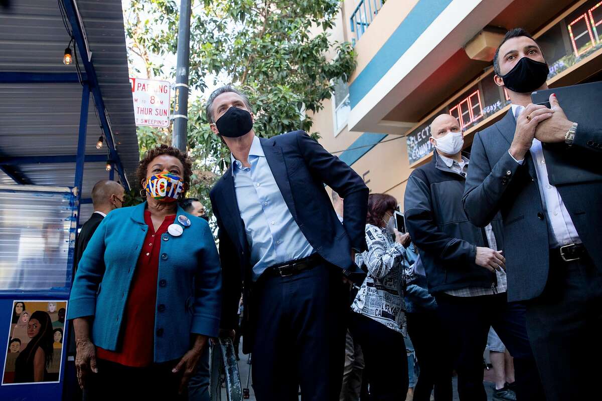 California Governor Gavin Newsom poses for a picture with Congresswoman Barbara Lee after phone and text banking for democratic candidates while outside of Manny's cafe and communal space in San Francisco, Calif. Tuesday, November 3, 2020. California elected officials gathered to phone bank for Joe Biden and Kamala Harris as well as other democratic candidates in battleground states.