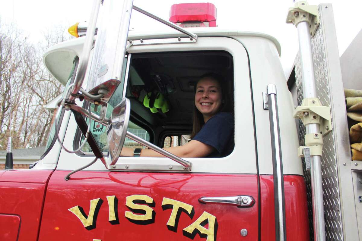New Canaan native Elly Hersam, now a firefighter and EMT in Vista, N.Y., while pursuing a master's degree, arrives in a Vista fire truck at a celebration of her grandfather V. Donald Hersam Jr.'s 90th birthday Friday, Nov. 27. Her grandfather is former Advertiser publisher and was chief of New Canaan Fire Company No. 1.