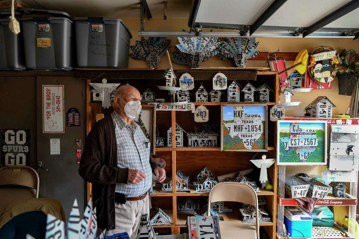 Edgar Fischel, who turns 93 on Dec. 2, stands in his garage amid his creations on Thursday, Nov. 12, 2020. A retired educator, Fischel’s hobby has been building homes, not for people, but for birds and bats using old license plates and other recycled materials.