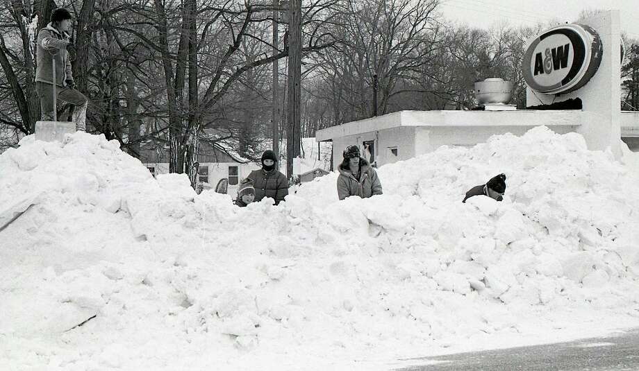 Shoveling snow at the former A &amp; W after the blizzard of January 1978. According to National Weather Service records, "The incredible blizzard of January 26-27, 1978 evolved out of a winter that was infamous for cold and storms. The winter of 1977-78 thus far had been one the coldest, since records began, in many areas from the Rockies eastward to the Appalachians."  (Manistee County Historical Museum photo)