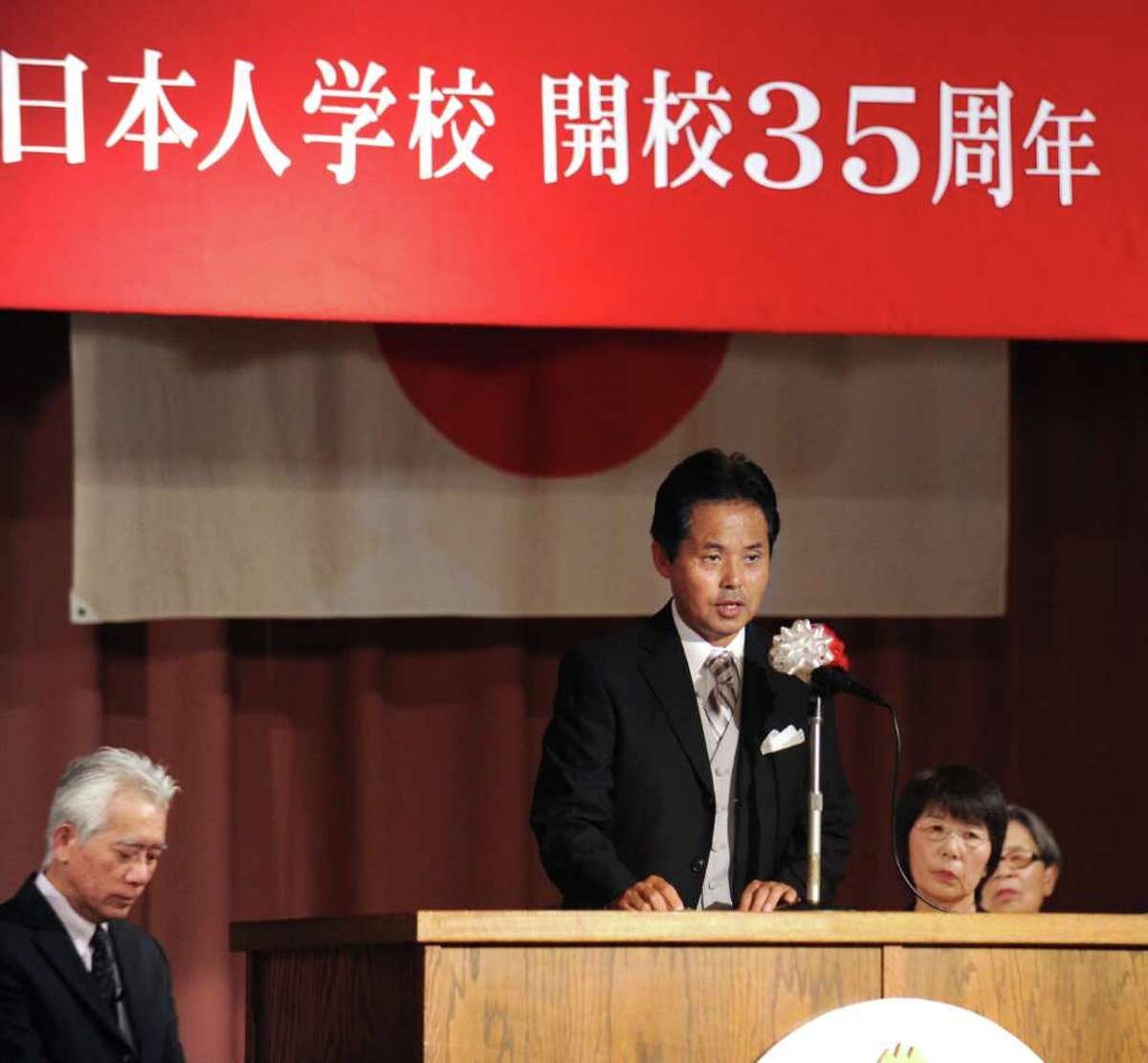 Tomoyuki Mitsui, center, principal of the Japanese School of New York located on Lake Avenue, Greenwich, addresses the audience during the celebration of the 35th anniversary of the school's founding, at the school, Thursday. Sept. 2, 2010.