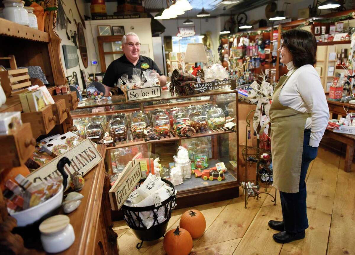 Owners Michael and Liz Sweeney pose at the new Cedar Corners General Store in Stamford, Conn., on Tuesday, Nov.17, 2020. Located at 932 High Ridge Road, the store featuring gifts, provisions, candy, and clothing hopes to “take a journey back to that simpler time and experience a blend of local, unique and fun gifts and accessories in an upbeat, old time turn-of-the-century charm.”