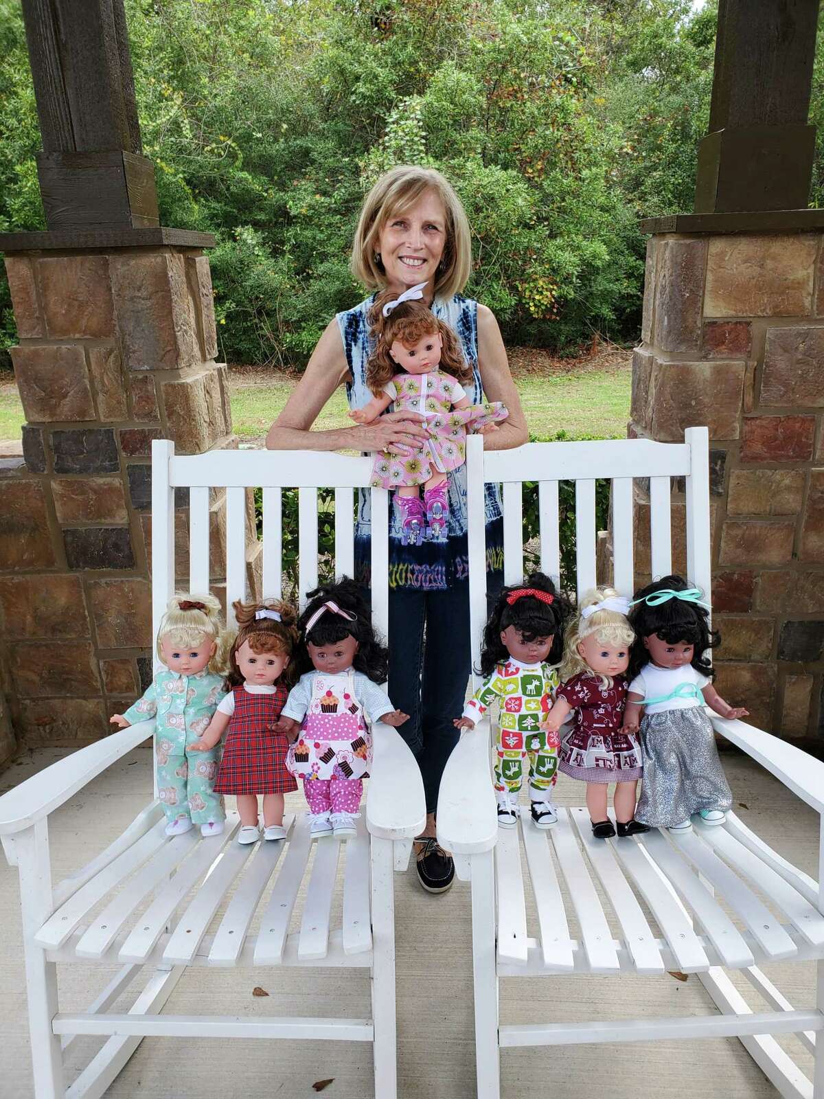 Ruth Parrish shows off the dolls she dressed for this year’s event.