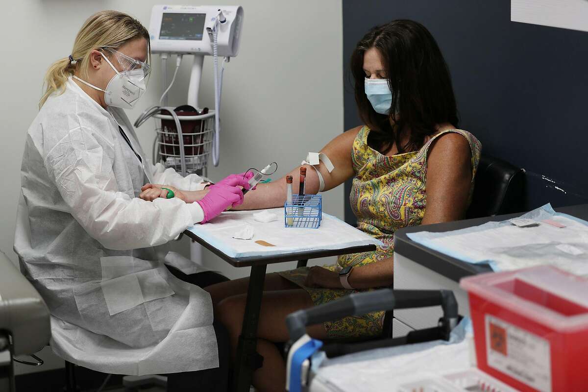 Blood is drawn from a participant in a COVID-19 vaccination study at Research Centers of America in Hollywood on Aug. 7.