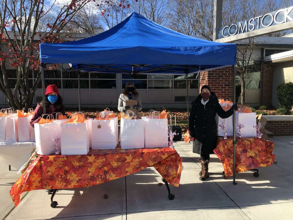 The Wilton Woman’s Club provided Thanksgiving meals to 155 older adults at a drive-thru event on Nov. 18. Standing by to hand them out at Comstock Community Center are, from left, Maria Wilcox of the woman's club; Stephanie Rowe of Wilton Social Services; and Liz Salguero of the woman's club.