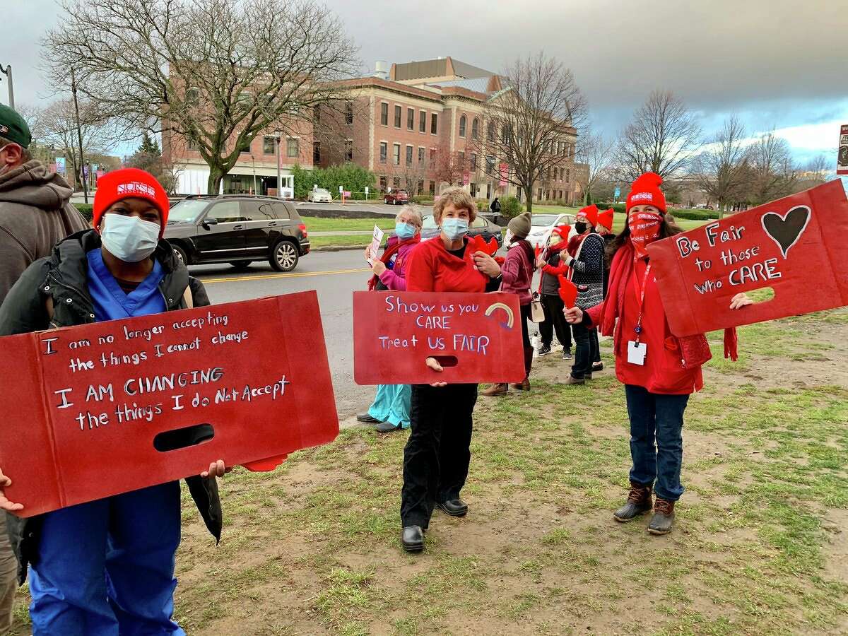 Britt Moore, Sandra Hautau and Cindy Dollard pose with signs. The Albany Medical Center nurses have decades of experience between them, and say throughout that time they feel as if they have no voice. If the hospital takes one message from today, they hope it is: “Listen to your nurses.”
