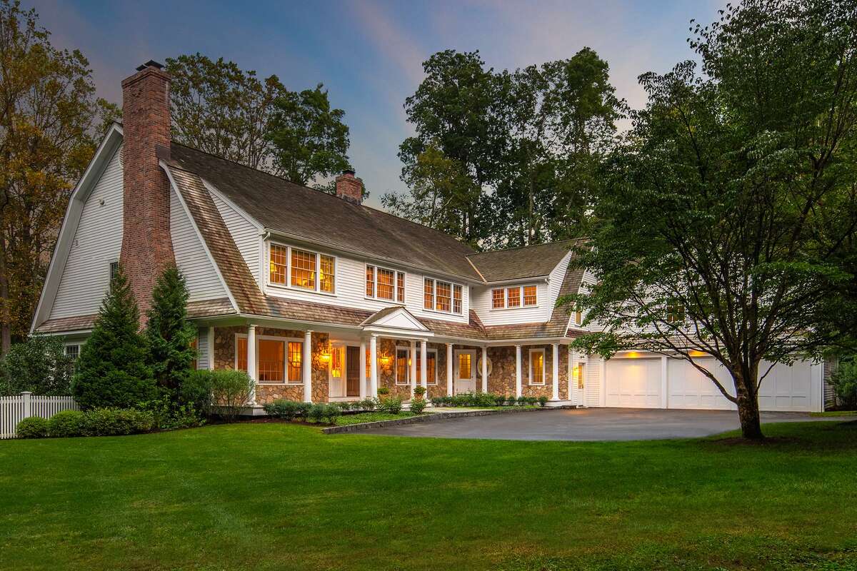 The stone and wood colonial house at 6 Cobble Hill Road sits on a one-acre level property on a cul-de-sac in Westport's Old Hill neighborhood. It was built in 2012 with modern amenities