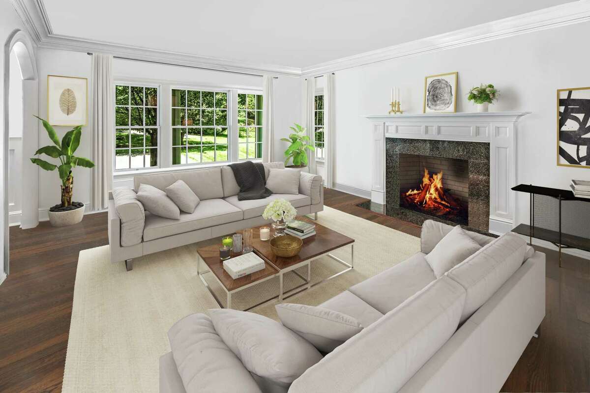 In the formal living room there is a fireplace with sophisticated molding on the mantel. (virtually staged) The library, which could be pressed into service as a home office, features a coffered ceiling, a built-in window seat and nearly floor-to-ceiling bookshelves. In the family room, the lower half of a red brick wall houses a fireplace. This room is open to the gourmet kitchen and breakfast room; the three combining to create a great room.