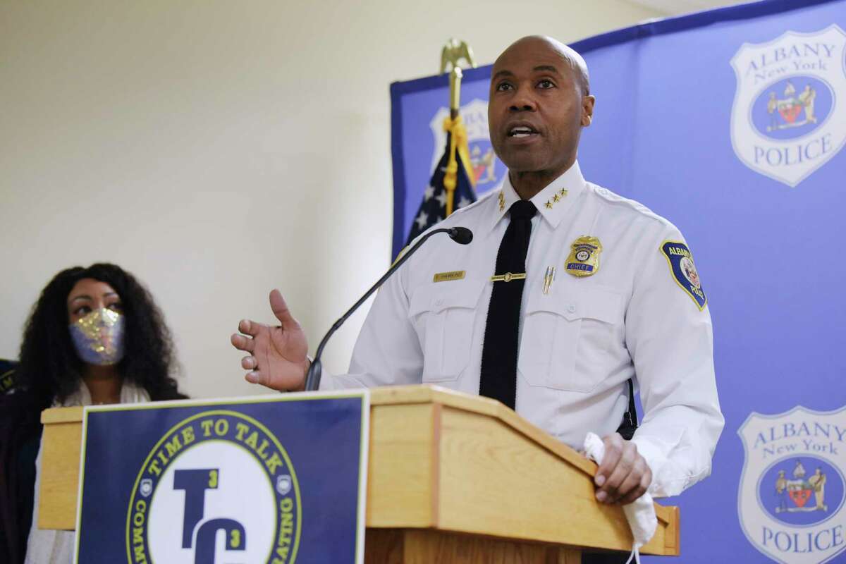 Albany Police Chief Eric Hawkins speaks at a press conference to announce the launch of Time to Talk - Community and Cops Collaborating, on Tuesday, Dec. 1, 2020, in Albany, N.Y. The program will allow for police officers and community members to meet on a regular basis to discuss the issues impacting the relations between police and the community. Albany resident April Purcell-Bacon, background, played a major role in starting the program. (Paul Buckowski/Times Union)