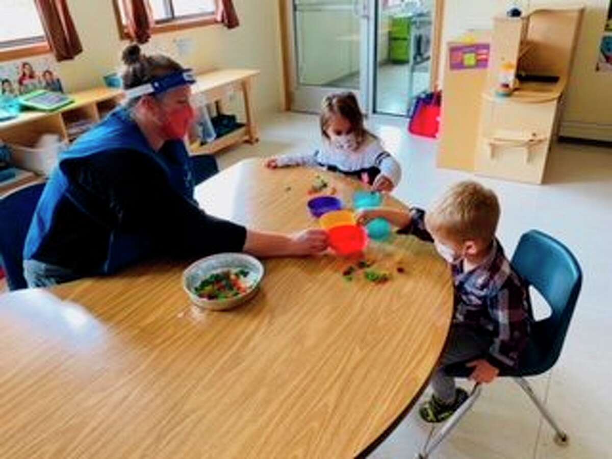 Head Start students enjoy a color sorting activity while adhering to safety precautions at the Northern Manistee Child Development Center. (Courtesy photo)
