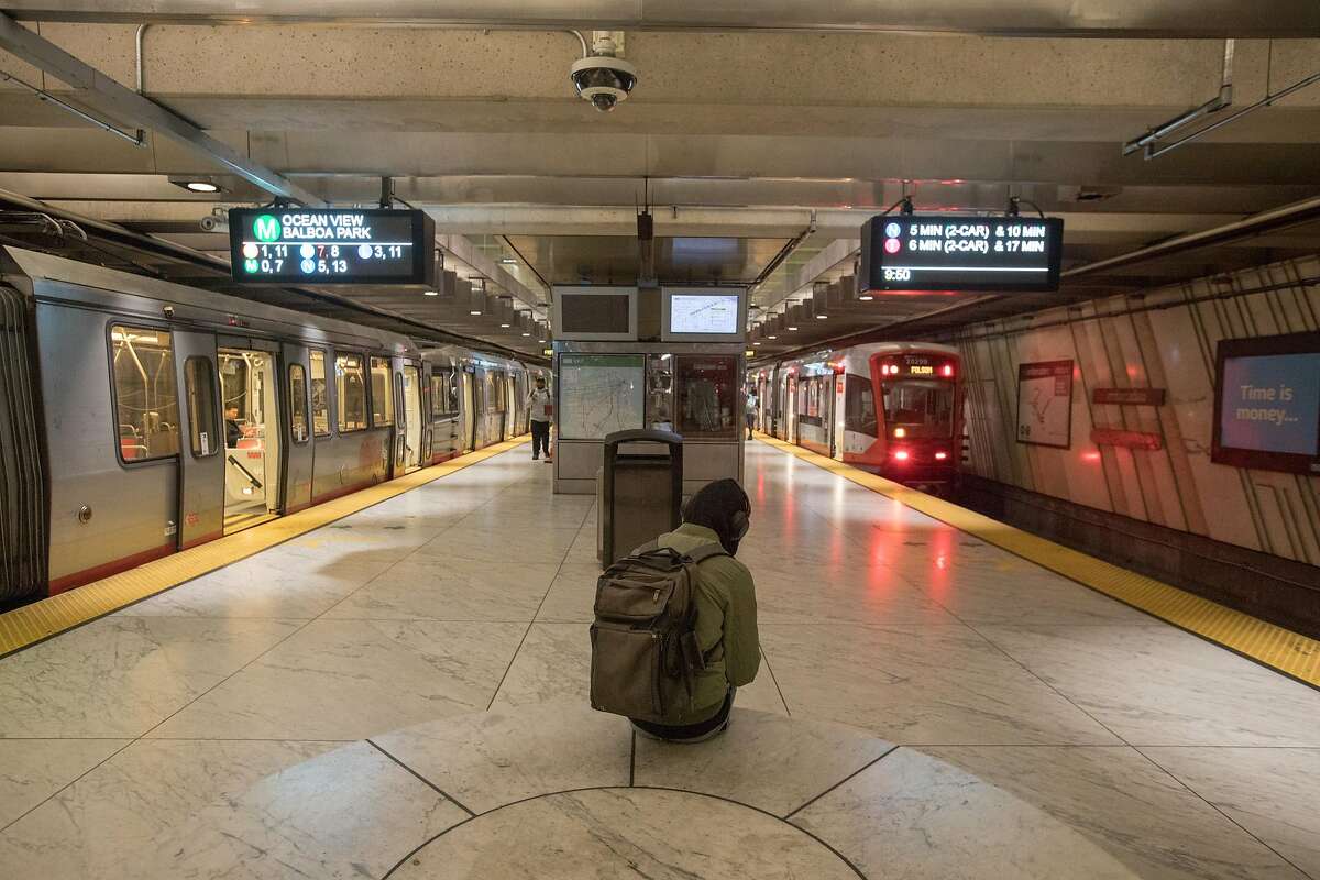 A passenger waits for a train at the Embarcadero Station. Traffic on the San Francisco MUNI subway was unusually light during rush hour in San Francisco, Calif. on March 10, 2020. The numbers of commuters on mass transit has dropped noticeably because of the coronavirus, which has triggered a budget deficit for the transit agency.