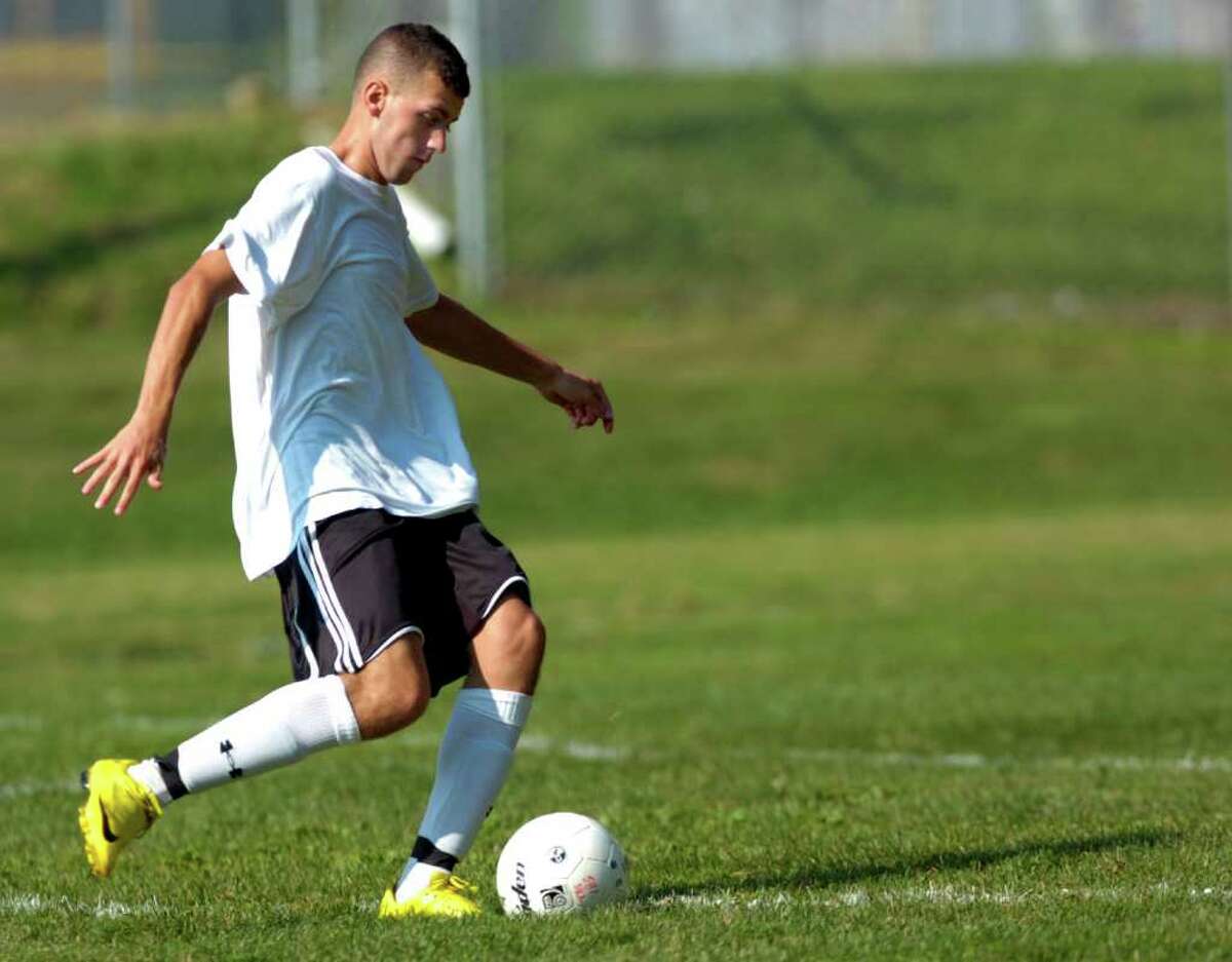 Manny Pereira maintains possession of the ball during Trumbull's soccer scrimmage against Amity on Thursday, September 2, 2010.