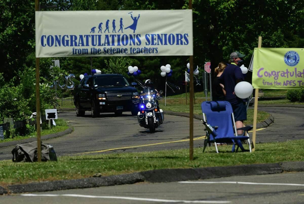Class of 2020 graduates join in a motorcade to Staples High School for a drive-through commencement ceremony Friday, June 12, 2020, in Westport, Conn.