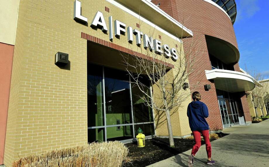 Patrons visit the LA Fitness Norwalk location to find that it has been closed Wednesday, December 2, 2020, at iPark in Norwalk, Conn. The Norwalk Health Department and Norwalk Police Department signed a closure order for LA Fitness today due to several repeated violations of State of Connecticut sector rules. Violations include patrons not wearing facemasks or other cloth face coverings, failure to maintain six feet of space between equipment and people, and failure to enforce the revised capacity limits. Photo: Erik Trautmann / Hearst Connecticut Media / Norwalk Hour