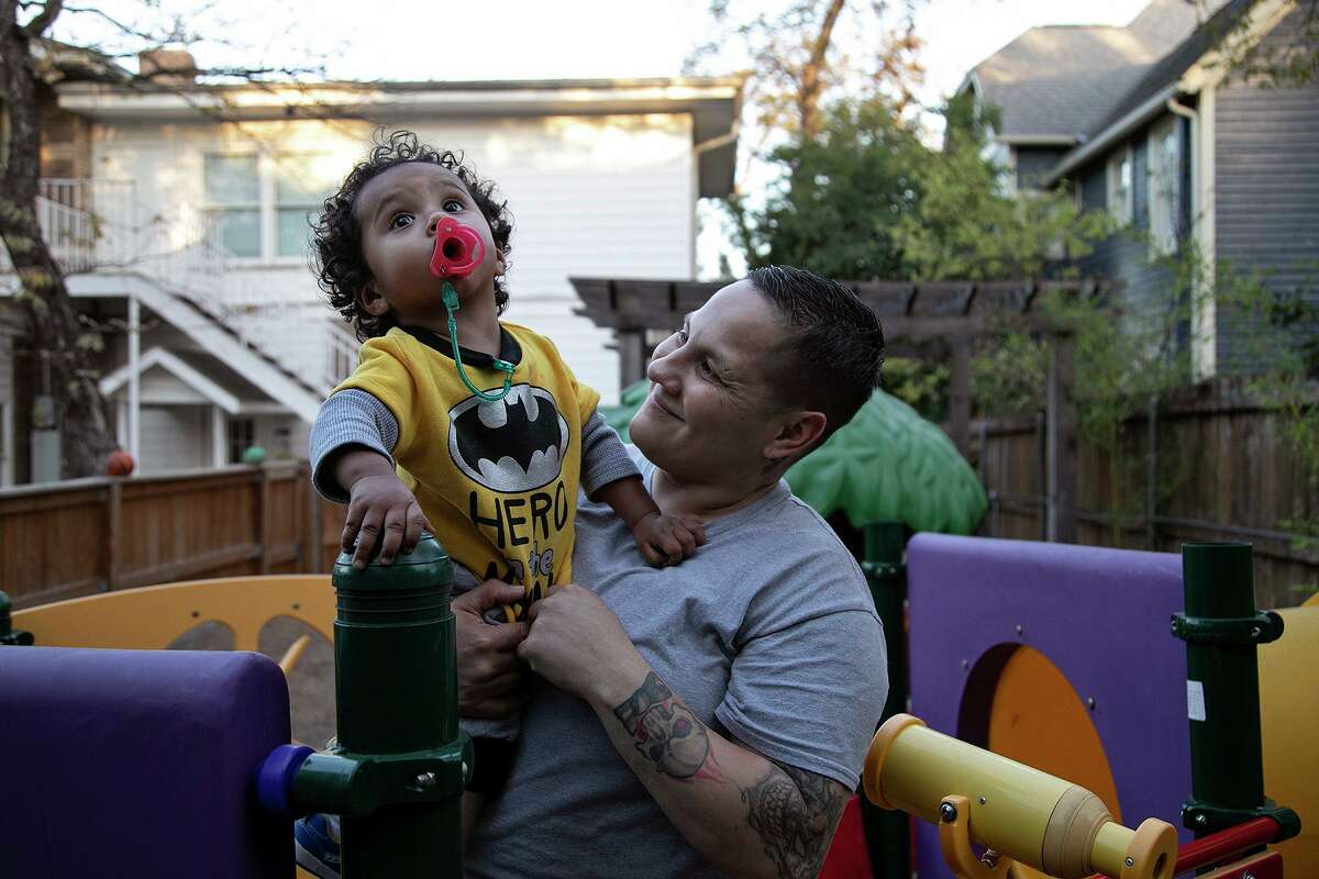 Genevieve Poblano holds her 19-month-old son, Ayden Poblano, in the backyard at Casa Mia in Monte Vista on Nov. 16.