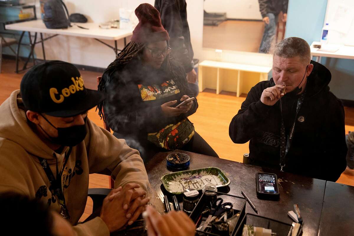 Ivan Castro (left), Showboat, Shawna Richards, and Kevin Tevin sit in the smoking room of Berner'’ on Haight.
