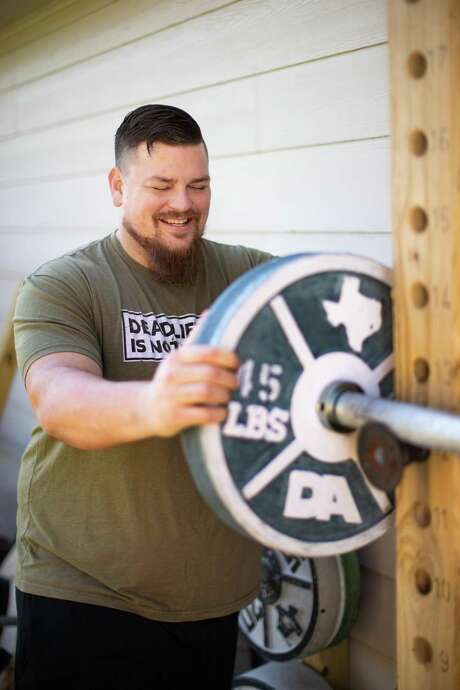 Dave Accardo, creator of weight plate mold for concrete weights at his home gym, Wednesday, Nov. 18, 2020, in Friendswood. His business Stix and Stone was created during the COVID-19 when people wanted to work out but couldn't find equipment. Photo: Marie D. De Jesús, Staff Photographer / © 2020 Houston Chronicle